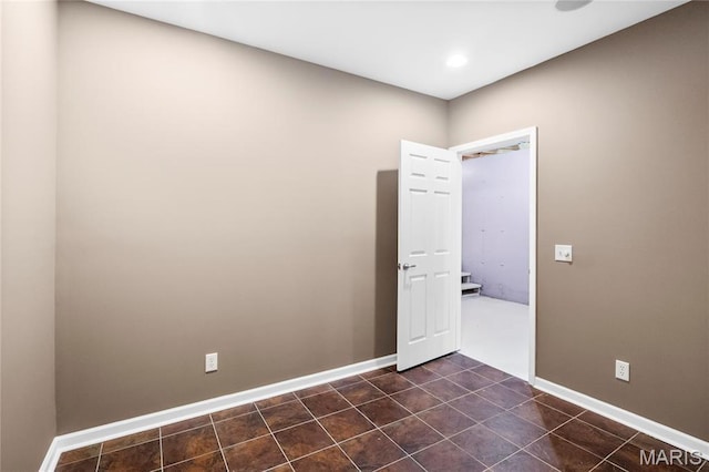 2521 High School Dr, Saint Louis, MO 63144 - empty room featuring dark tile patterned flooring and baseboards