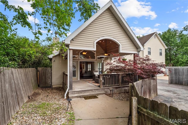 2521 High School Dr, Saint Louis, MO 63144 - rear view of property featuring ceiling fan, a fenced backyard, and a chimney