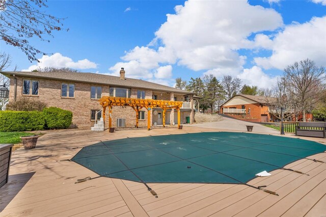 8620 State Route 163, Belleville, IL 62223 - view of swimming pool with a pergola, a deck, and a covered pool