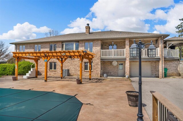 8620 State Route 163, Belleville, IL 62223 - back of house featuring a pergola, a chimney, brick siding, a covered pool, and cooling unit