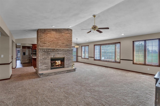 8620 State Route 163, Belleville, IL 62223 - unfurnished living room with vaulted ceiling, a ceiling fan, carpet, a fireplace, and baseboards