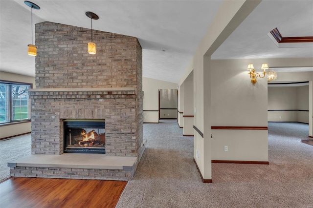 8620 State Route 163, Belleville, IL 62223 - unfurnished living room featuring vaulted ceiling, carpet flooring, baseboards, a fireplace, and a chandelier