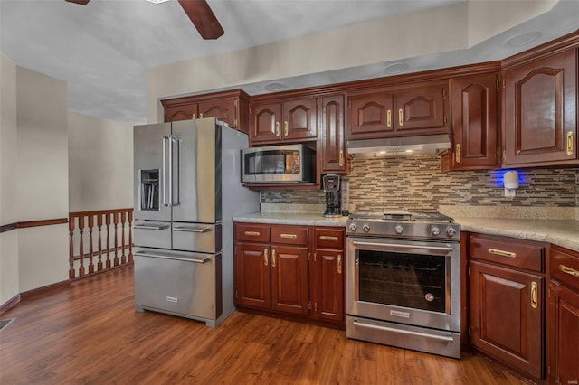 8620 State Route 163, Belleville, IL 62223 - kitchen with appliances with stainless steel finishes, under cabinet range hood, a ceiling fan, light countertops, and decorative backsplash