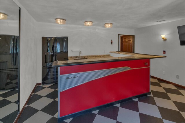 8620 State Route 163, Belleville, IL 62223 - kitchen featuring tile patterned floors, a sink, black refrigerator with ice dispenser, and baseboards
