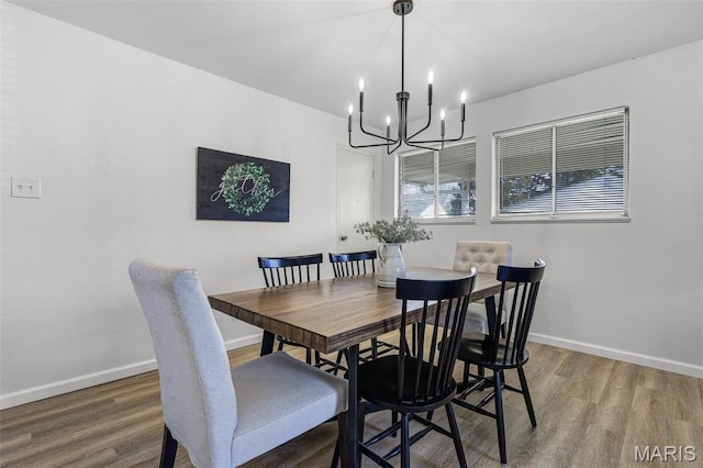 35 Florissant Park Dr, Florissant, MO 63031 - dining space with a chandelier, wood finished floors, and baseboards