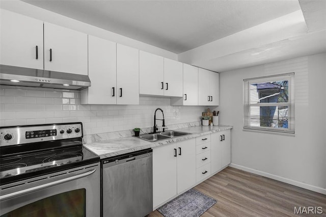 35 Florissant Park Dr, Florissant, MO 63031 - kitchen with appliances with stainless steel finishes, under cabinet range hood, a sink, baseboards, and backsplash