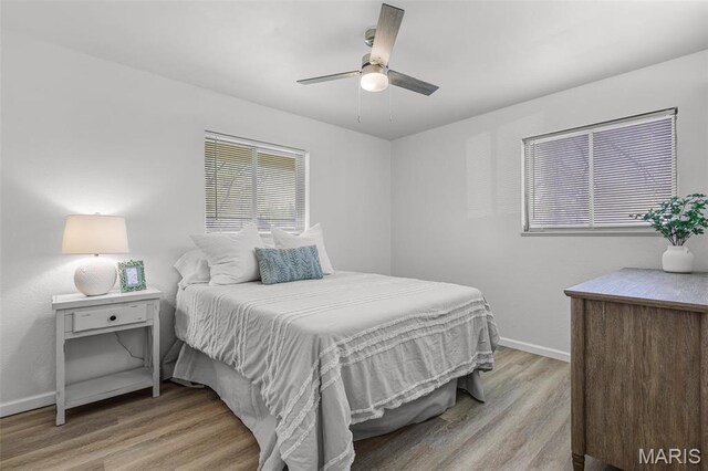 35 Florissant Park Dr, Florissant, MO 63031 - bedroom featuring light wood-style floors, baseboards, and a ceiling fan