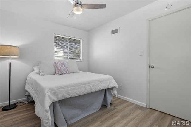35 Florissant Park Dr, Florissant, MO 63031 - bedroom featuring wood finished floors, a ceiling fan, and baseboards