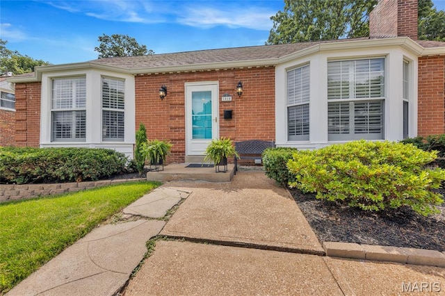 1010 Briarton Dr, Saint Louis, MO 63126 - entrance to property with brick siding, a chimney, and a shingled roof