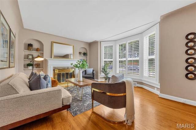 1010 Briarton Dr, Saint Louis, MO 63126 - living room with a fireplace, built in shelves, and wood finished floors