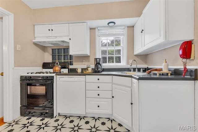 1010 Briarton Dr, Saint Louis, MO 63126 - kitchen featuring dishwasher, gas stove, under cabinet range hood, dark countertops, and white cabinetry
