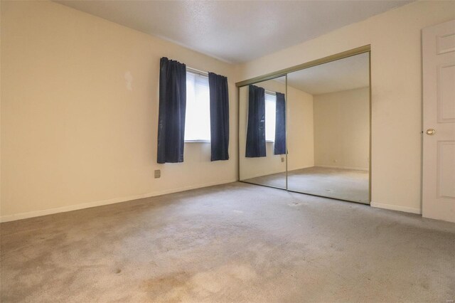 2781 Blackforest Dr Unit C, Saint Louis, MO 63129 - unfurnished bedroom featuring carpet flooring, a closet, and baseboards