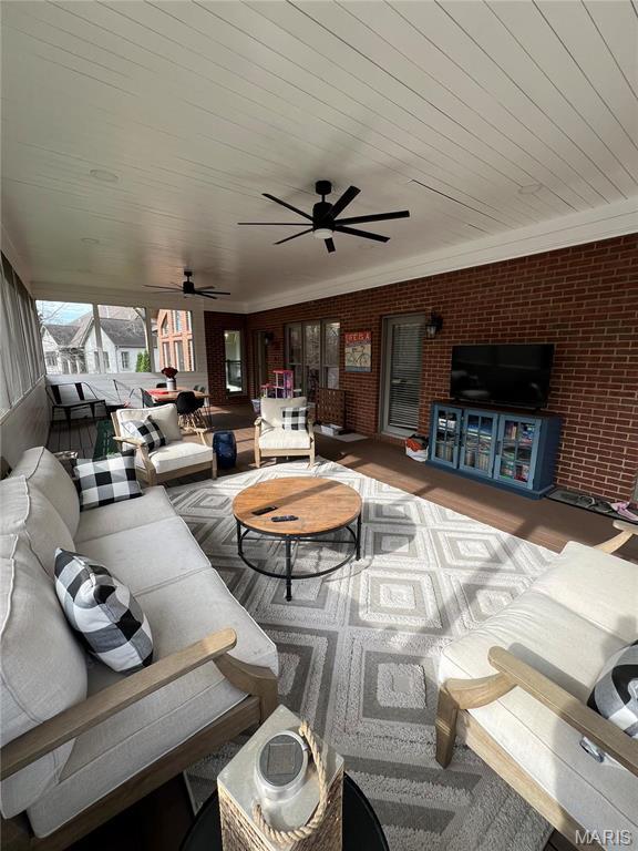 living room featuring brick wall, ceiling fan, and wooden ceiling