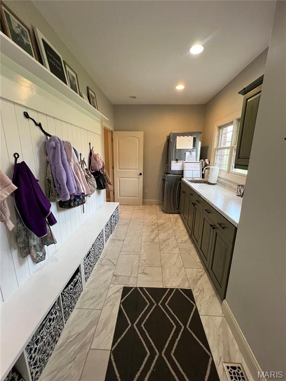 mudroom with light marble finish floors and recessed lighting