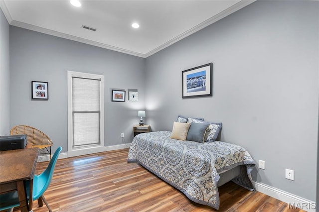 bedroom with ornamental molding, baseboards, light wood-type flooring, and recessed lighting