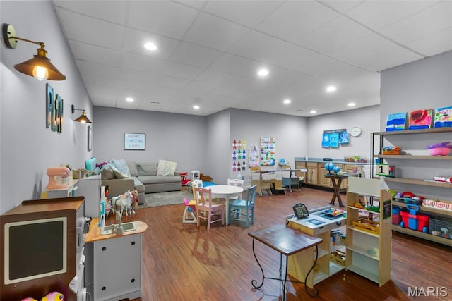 game room featuring wood finished floors and a drop ceiling