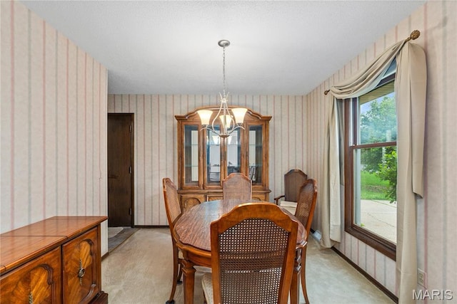 dining area featuring wallpapered walls, light colored carpet, and a chandelier