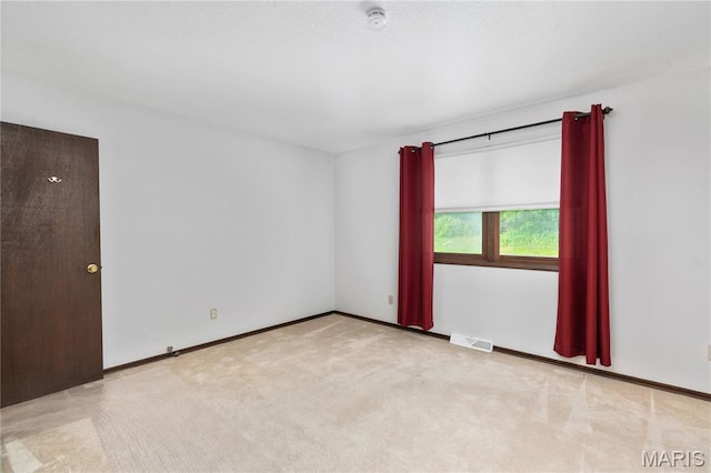 unfurnished room featuring a smoke detector, carpet, and baseboards