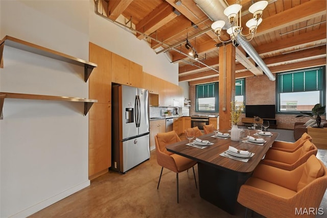 901 Washington Ave Unit 310, Saint Louis, MO 63101 - dining room with wood ceiling with exposed beams, a chandelier, finished concrete floors, baseboards, and a high ceiling