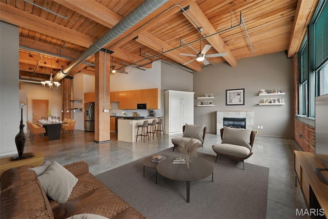 901 Washington Ave Unit 310, Saint Louis, MO 63101 - living area with concrete flooring, wood ceiling with exposed beams, a fireplace, a high ceiling, and ceiling fan