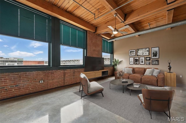 901 Washington Ave Unit 310, Saint Louis, MO 63101 - living area featuring wood ceiling with exposed beams, brick wall, ceiling fan, and concrete flooring