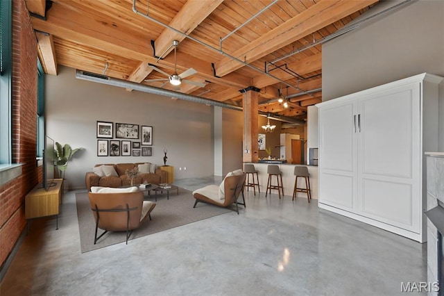 901 Washington Ave Unit 310, Saint Louis, MO 63101 - living area featuring finished concrete floors, wooden ceiling with exposed beams, and a ceiling fan