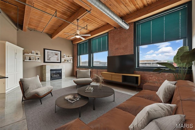901 Washington Ave Unit 310, Saint Louis, MO 63101 - living room featuring brick wall, wooden ceiling with exposed beams, a tiled fireplace, ceiling fan, and finished concrete flooring