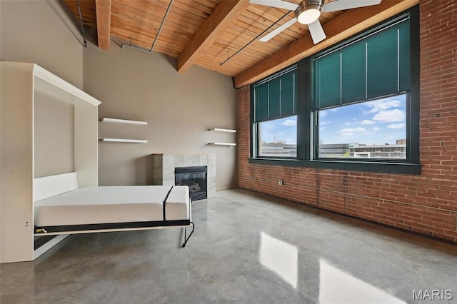 901 Washington Ave Unit 310, Saint Louis, MO 63101 - office with wooden ceiling with exposed beams, concrete flooring, brick wall, a tiled fireplace, and ceiling fan