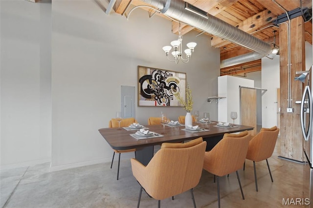901 Washington Ave Unit 310, Saint Louis, MO 63101 - dining room with a towering ceiling, finished concrete flooring, a chandelier, electric panel, and baseboards