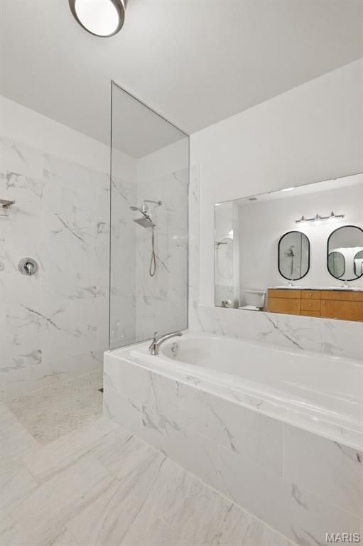 901 Washington Ave Unit 310, Saint Louis, MO 63101 - bathroom with a garden tub, a marble finish shower, marble look tiles, and toilet
