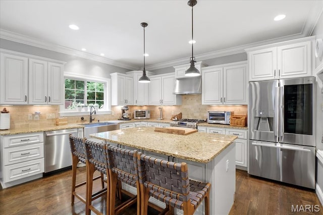 17 Denver Pl, Saint Louis, MO 63119 - kitchen featuring appliances with stainless steel finishes, a breakfast bar area, a kitchen island, white cabinetry, and dark wood-style flooring