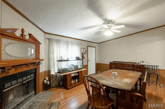 19518 State Highway Ww, Puxico, MO 63960 - dining room with a textured ceiling, light wood finished floors, crown molding, a glass covered fireplace, and ceiling fan