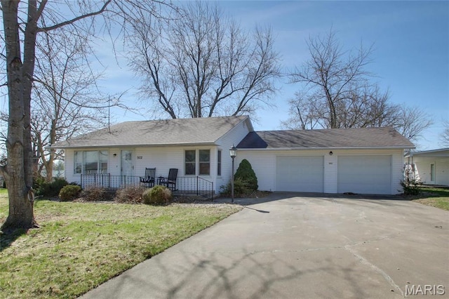 902 E Morgan St, Edina, MO 63537 - view of front of home with a porch, concrete driveway, an attached garage, and a front yard