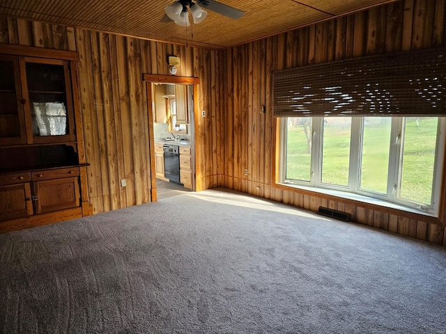 1501 S Main St, Hillsboro, IL 62049 - unfurnished living room with ceiling fan, light colored carpet, wooden walls, and a sink