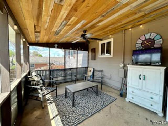 living room with concrete floors and ceiling fan