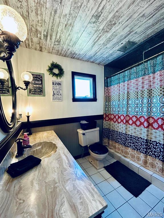 bathroom featuring wooden ceiling, tile patterned flooring, toilet, curtained shower, and vanity