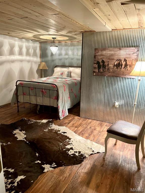 bedroom with wood-type flooring and wooden ceiling