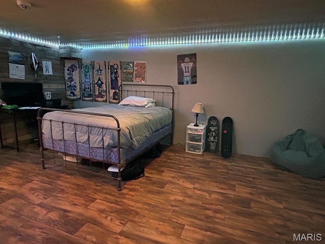 bedroom with wood finished floors and a fireplace