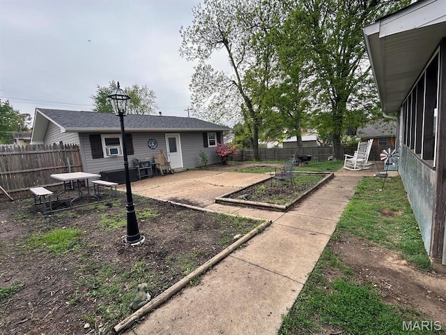 view of yard with a vegetable garden and fence