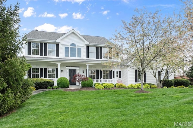 1114 Lockett Rd, Des Peres, MO 63131 - colonial house featuring covered porch, a front lawn, and a shingled roof
