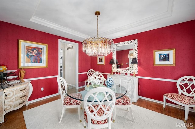 1114 Lockett Rd, Des Peres, MO 63131 - dining space with a raised ceiling, wood finished floors, a chandelier, baseboards, and ornamental molding