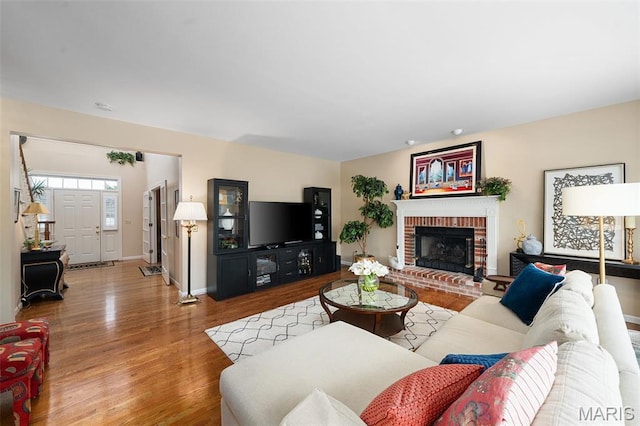 1114 Lockett Rd, Des Peres, MO 63131 - living room featuring wood finished floors, baseboards, and a fireplace