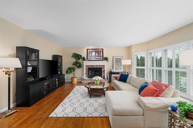 1114 Lockett Rd, Des Peres, MO 63131 - living area featuring baseboards, wood finished floors, and a fireplace