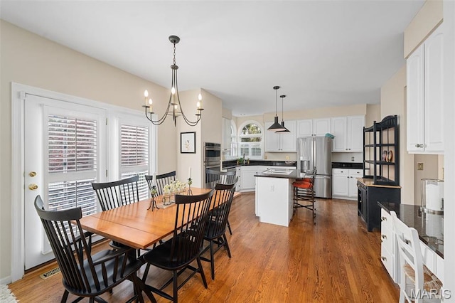1114 Lockett Rd, Des Peres, MO 63131 - dining space featuring wood finished floors and a chandelier