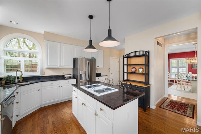 1114 Lockett Rd, Des Peres, MO 63131 - kitchen with appliances with stainless steel finishes, dark wood-type flooring, a sink, white cabinetry, and recessed lighting