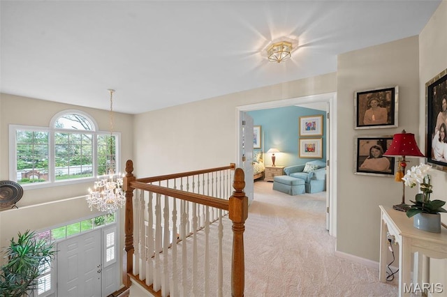 1114 Lockett Rd, Des Peres, MO 63131 - corridor featuring an upstairs landing, carpet, a chandelier, and baseboards