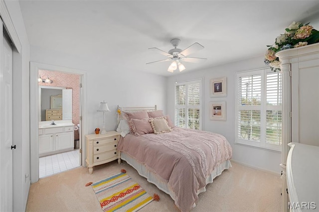 1114 Lockett Rd, Des Peres, MO 63131 - bedroom with light carpet, ensuite bathroom, a ceiling fan, and baseboards