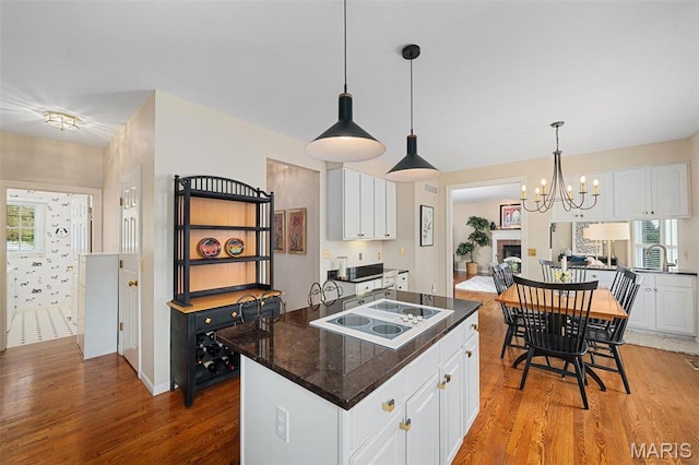 1114 Lockett Rd, Des Peres, MO 63131 - kitchen featuring white electric stovetop, light wood finished floors, and white cabinets