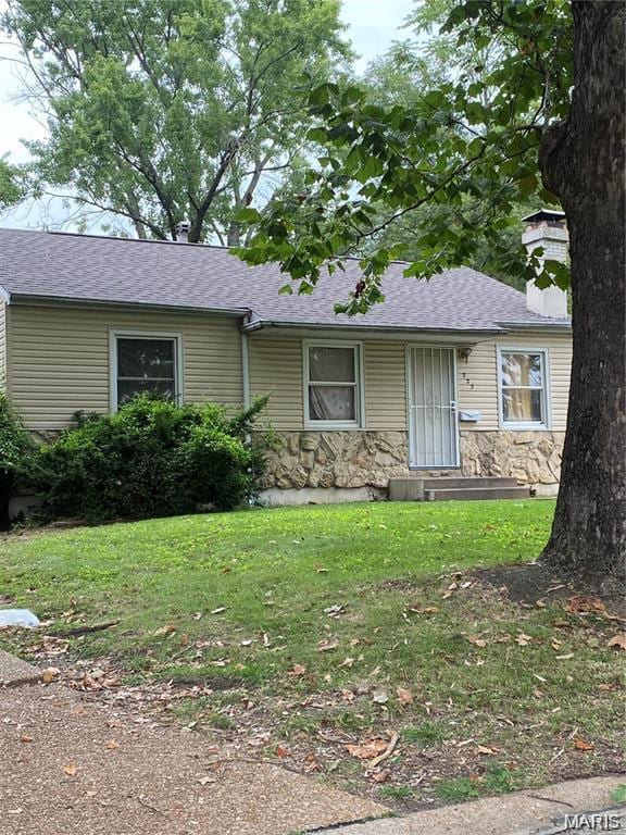 223 Presley Dr, Saint Louis, MO 63137 - view of front of house with a chimney, a front lawn, stone siding, and a shingled roof
