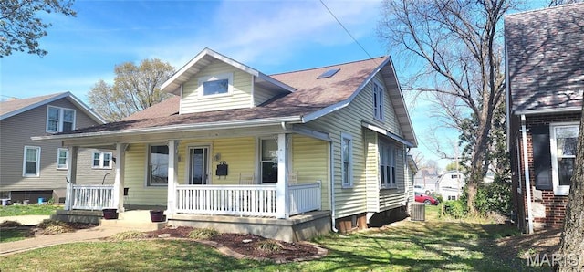 530 W Holmes, Chester, IL 62233 - bungalow featuring covered porch, a front yard, cooling unit, and a shingled roof